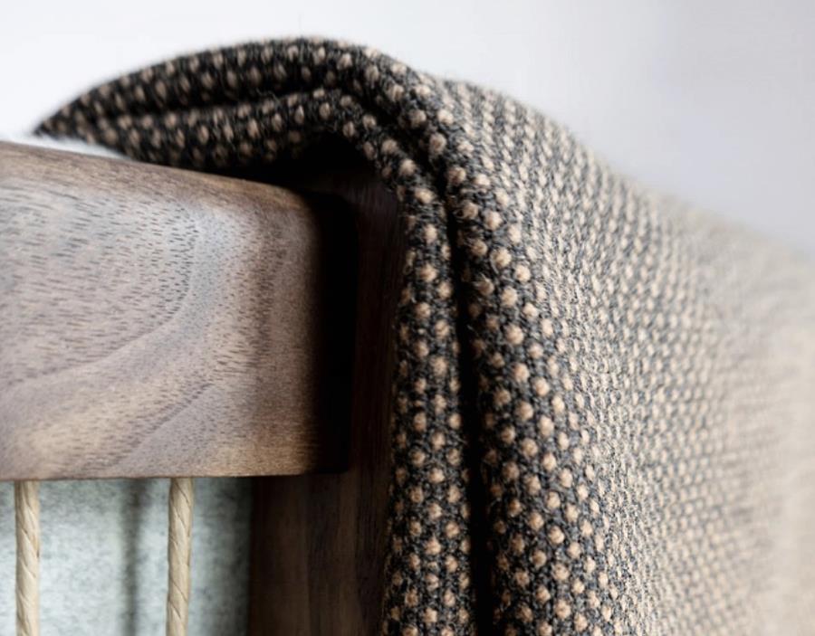Renewed Loop: recycled melange fabric draped over a timber chair arm