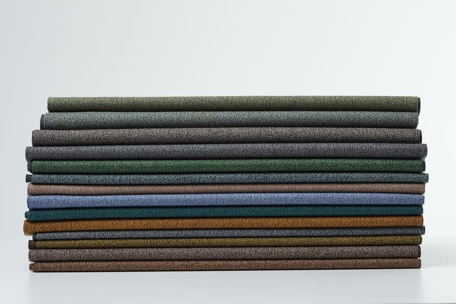 A tall stack of folded Svensson upholstery fabrics