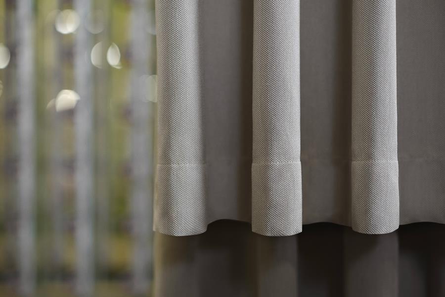 Sheer white Svensson curtains with trees beyond
