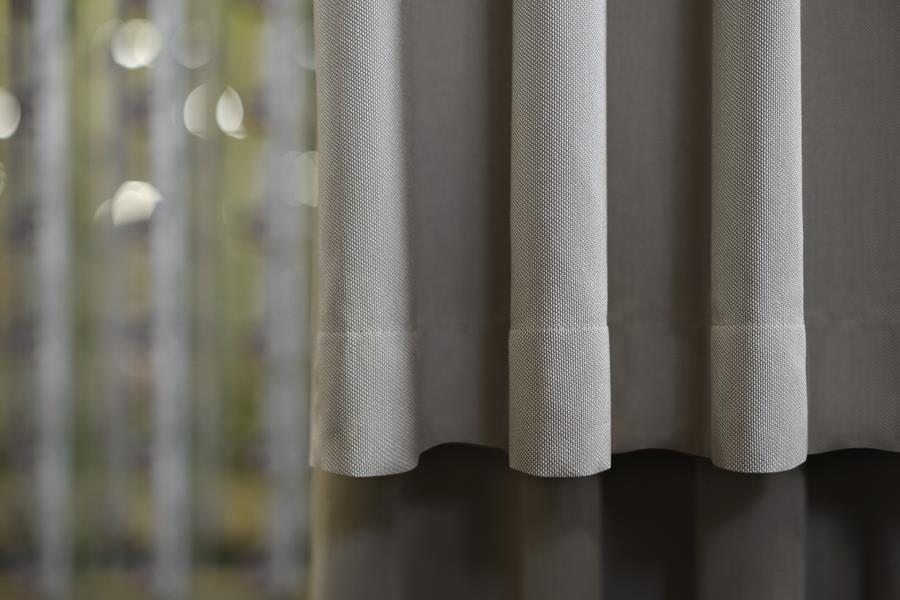 Sheer white Svensson curtains with trees beyond