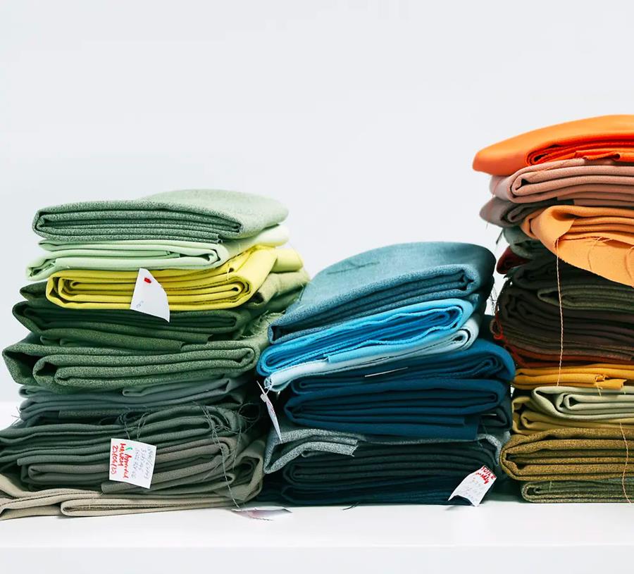 Stacked Gabriel fabrics in green, blue and orange