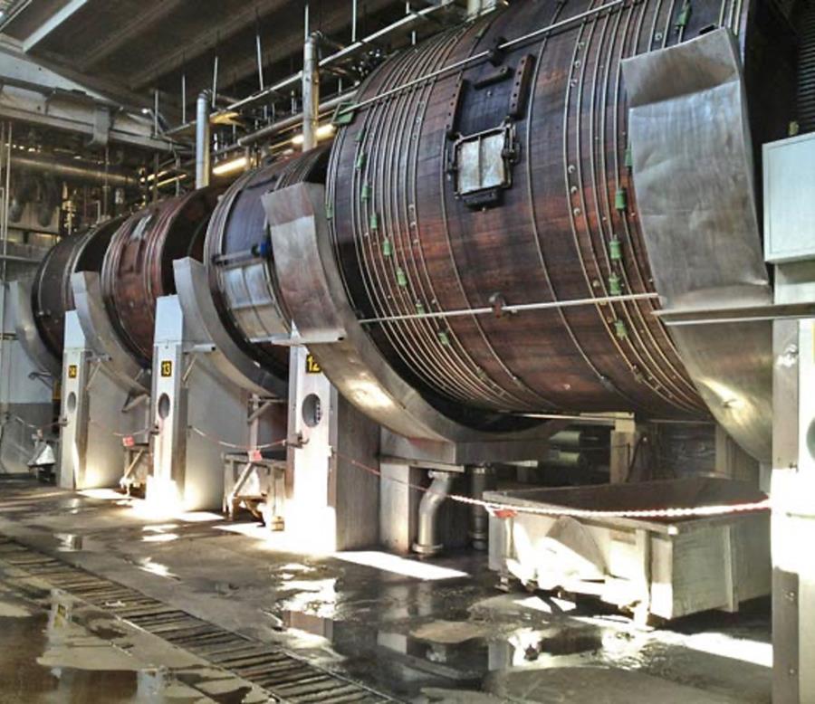 A row of wooden tanning drums in a tannery