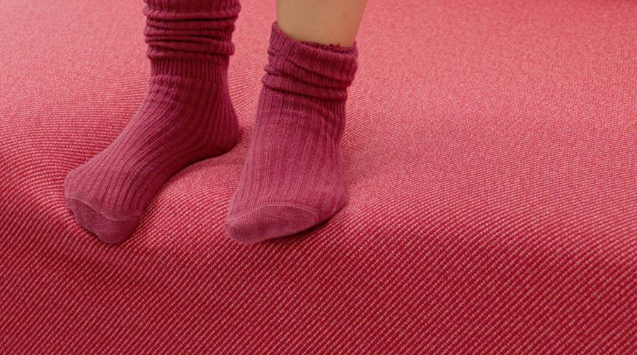 Feet in red socks on a red TwillWool seat